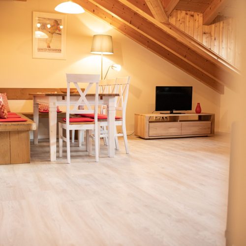 Wohnbereich mit Essbereich und Fernseher in Ferienwohnung in Garmisch-Partenkirchen