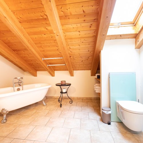 Badezimmer mit Schräge und Badewanne in Ferienwohnung in Garmisch-Partenkirchen