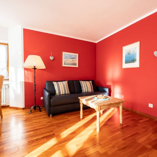 schwarzes Sofa und Stehlampe mit Couchtisch in Ferienwohnung in Garmisch-Partenkirchen