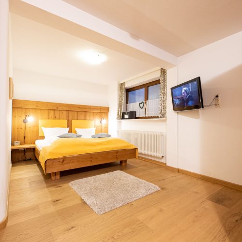Doppelbett mit Fernseher in Ferienwohnung in Garmisch-Partenkirchen