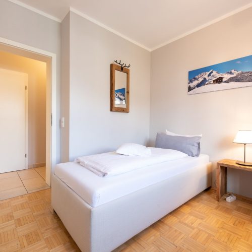 Einzelbett mit Spiegel in Ferienwohnung in Garmisch-Partenkirchen