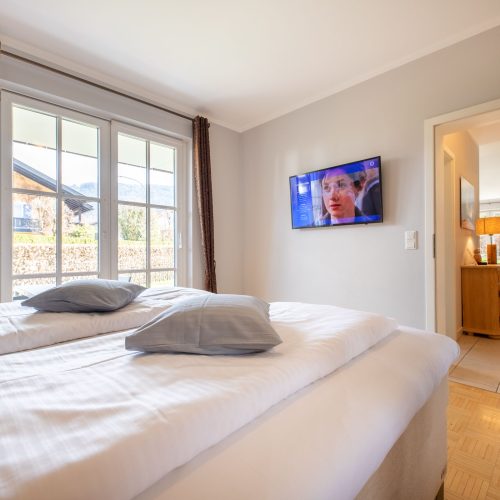 Doppelbett mit Fernseher in Ferienwohnung in Garmisch-Partenkirchen