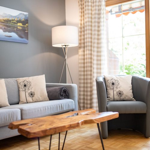 Sessel und Sofa mit Kissen in Ferienwohnung in Garmisch-Partenkirchen