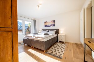Doppelbett und kleiner Nachtschrank in Ferienwohnung in Garmisch-Partenkirchen