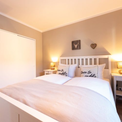 Helles Schlafzimmer mit braunen Wänden in Ferienwohnung in Garmisch-Partenkirchen