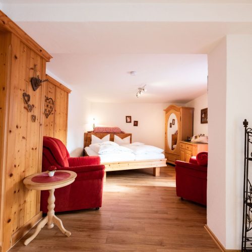 Schlafzimmer mit roten Sesseln in Ferienwohnung in Garmisch-Partenkirchen