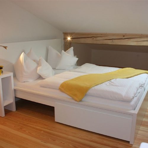 Doppelbett und Nachttisch in Ferienwohnung in Garmisch-Partenkirchen