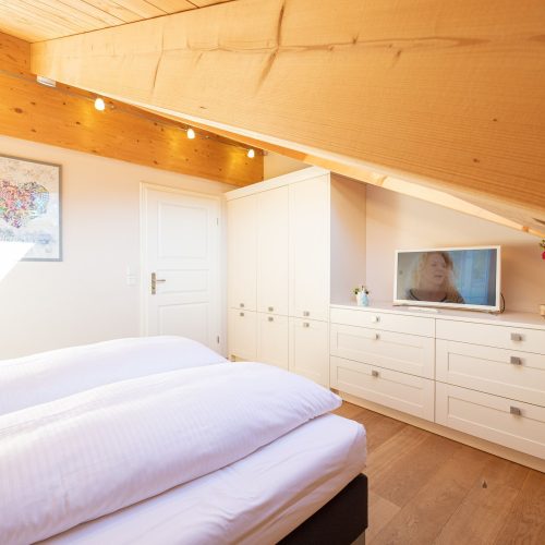 Doppelbett und Fernseher in Ferienwohnung in Garmisch-Partenkirchen