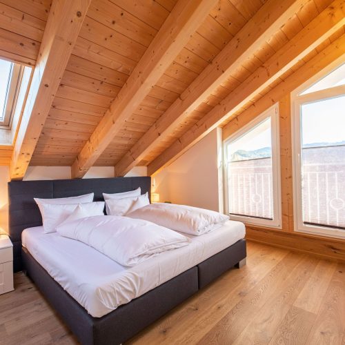 Doppelbett und Dachfenster in Ferienwohnung in Garmisch-Partenkirchen