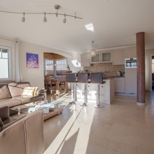 Wohnbereich mit Sofa und Küchen in Ferienwohnung in Garmisch-Partenkirchen