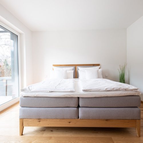 Doppelbett mit Holzrahmen in Ferienwohnung in Garmisch-Partenkirchen