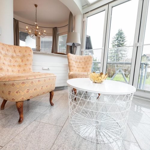 Sessel mit kleinem Tisch und Terrasse in Ferienwohnung in Garmisch-Partenkirchen