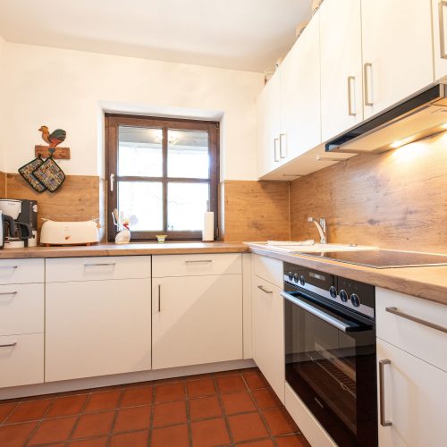 Küche mit brauner Arbeitsplatte in Ferienwohnung in Garmisch-Partenkirchen