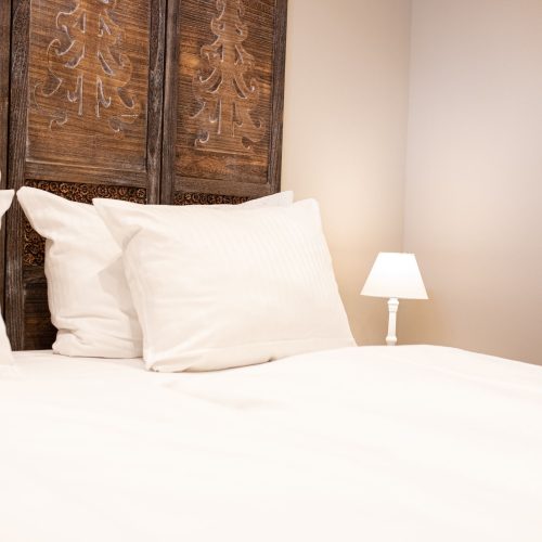 Bett mit weißem Bezug in Ferienwohnung in Garmisch-Partenkirchen