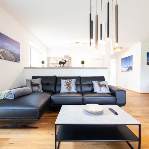 Wohnzimmer mit einem grauen Tisch in Ferienwohnung in Garmisch-Partenkirchen