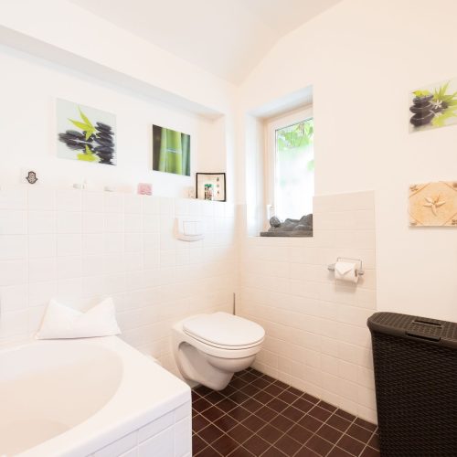 Badezimmer mit verschiedenen Bildern in Ferienwohnung in Garmisch-Partenkirchen