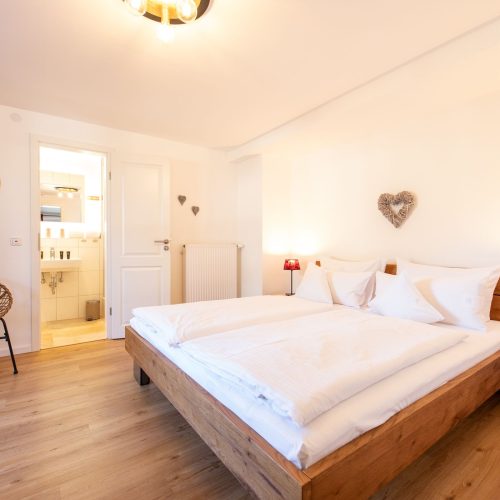Schlafzimmer mit Sitzmöglichkeit in Ferienwohnung in Garmisch-Partenkirchen