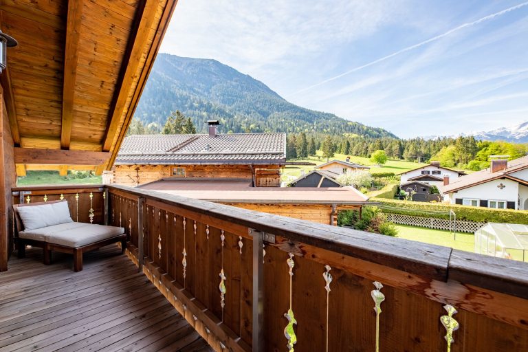 Holzbalkon mit Liegestuhl an Ferienwohnung in Garmisch-Partenkirchen
